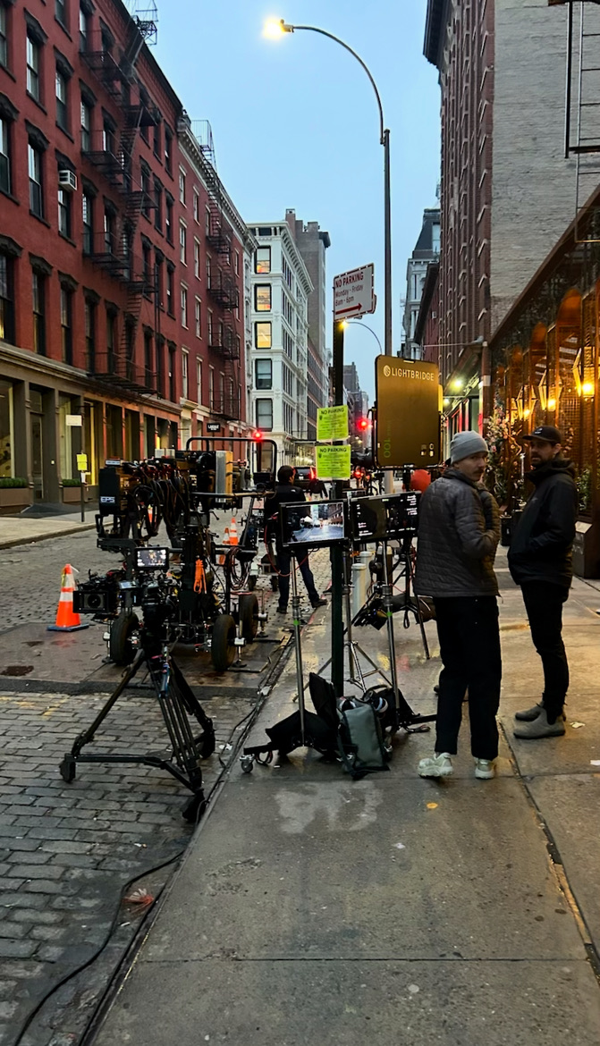 Film production on NYC cobblestone street at dawn
