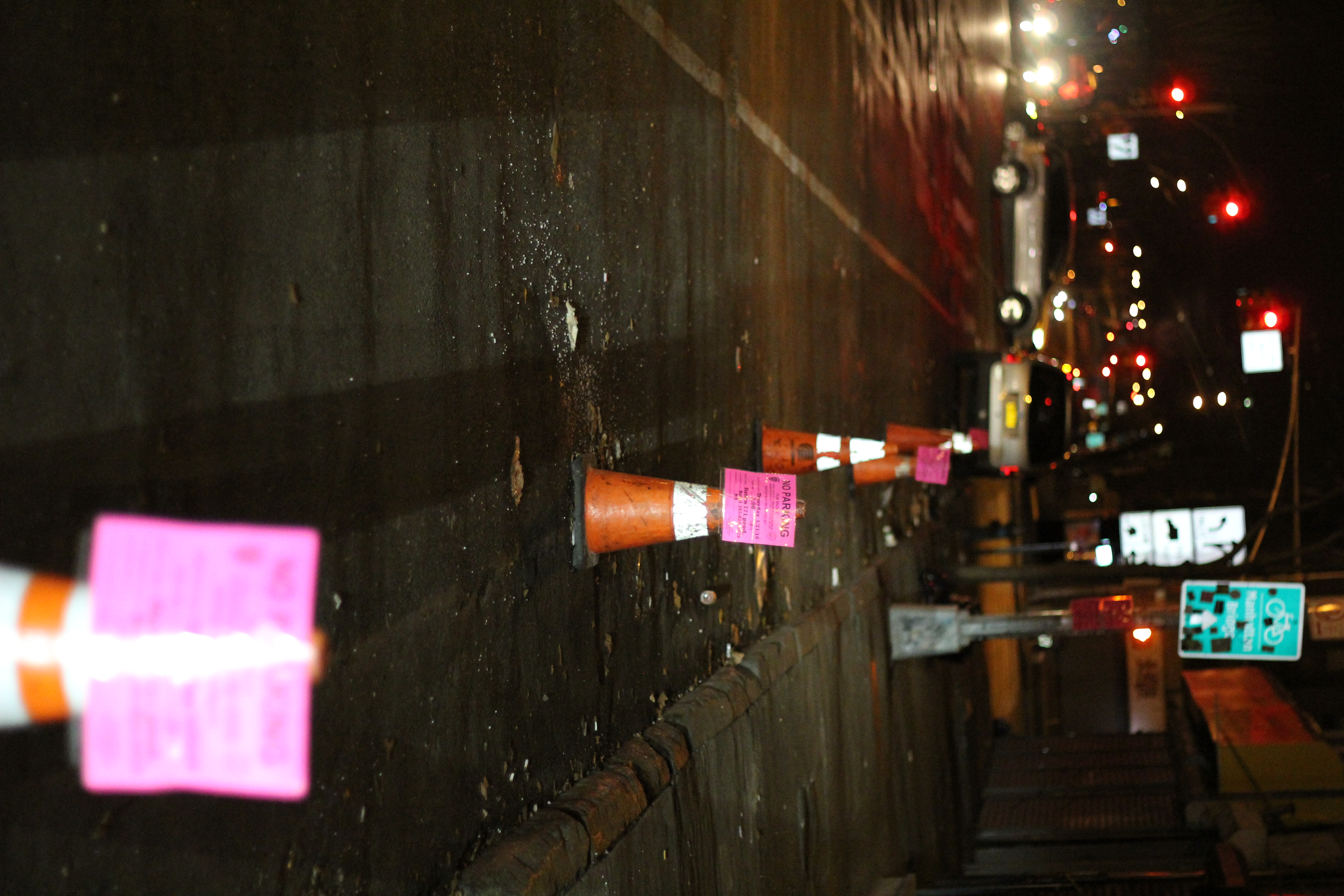 Night cones with pink no parking signs