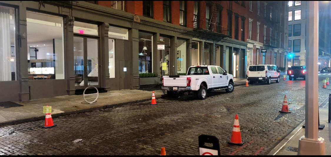 Production trucks held on NYC cobblestone street