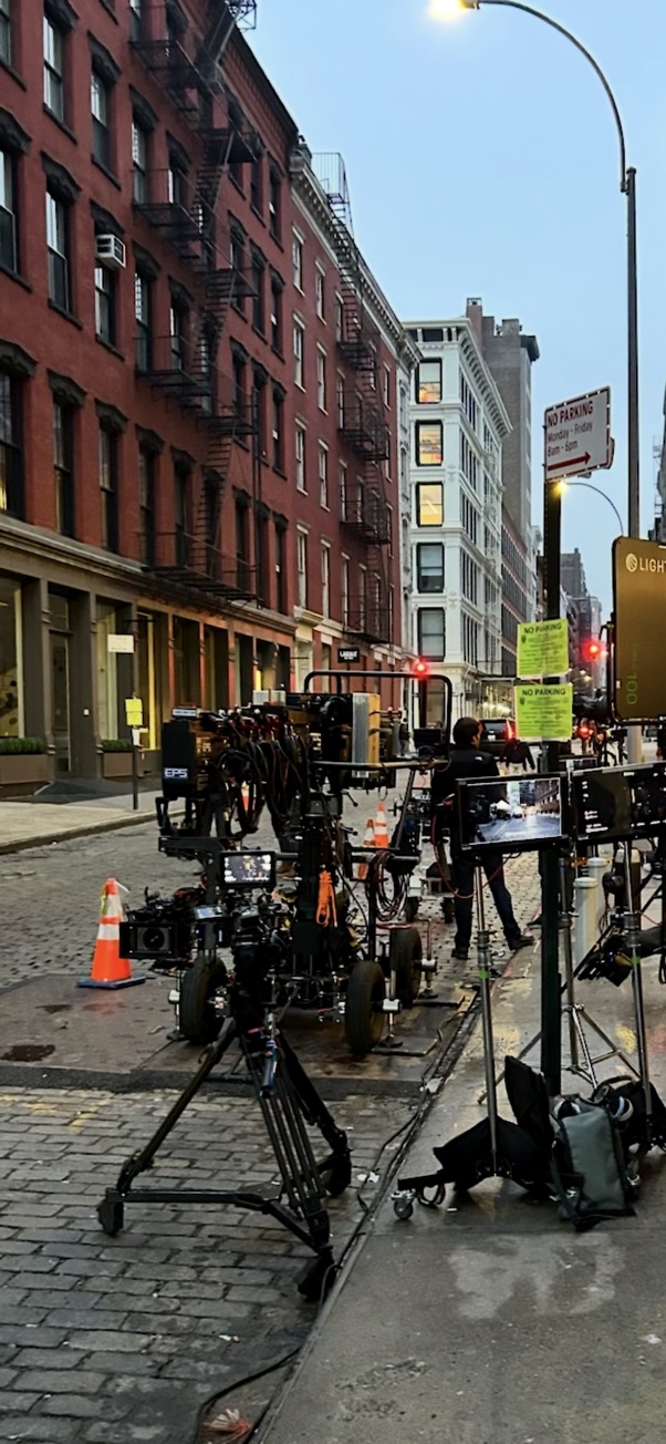 Camera equipment staged on NYC cobblestone street
